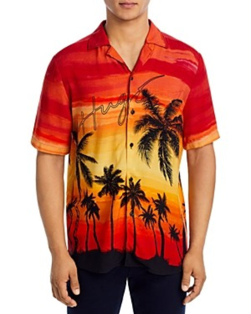 Translation missing: en.A man wearing a short-sleeve button-up camp shirt with a vibrant sunset and palm tree graphic, set against a plain white background