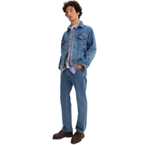 Translation missing: en.A young man modeling a light blue denim jacket and matching blue denim jeans, styled with a light purple button-down shirt and brown leather shoes, set against a plain white background
